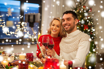 Image showing couple taking picture by selfie stick at christmas