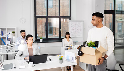 Image showing sad fired male office worker with personal stuff