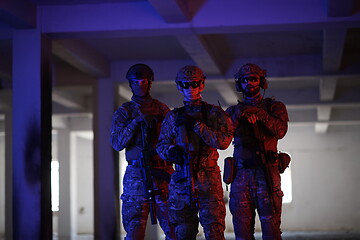 Image showing soldier squad team portrait in urban environment colored lightis