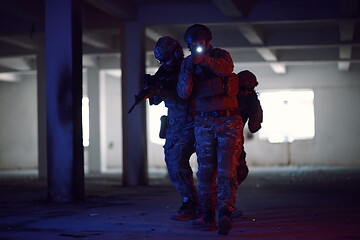 Image showing Soldiers squad in tactical formation having action urban environment