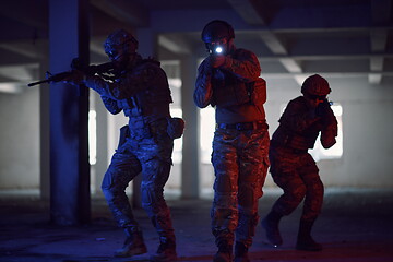 Image showing Soldiers squad in tactical formation having action urban environment