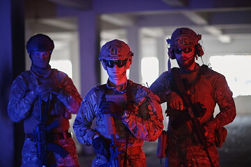 Image showing soldier squad team portrait in urban environment colored lightis