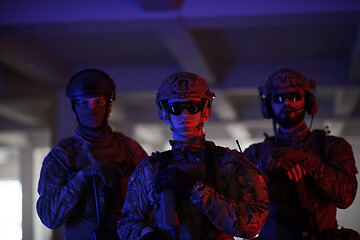 Image showing soldier squad team portrait in urban environment colored lightis