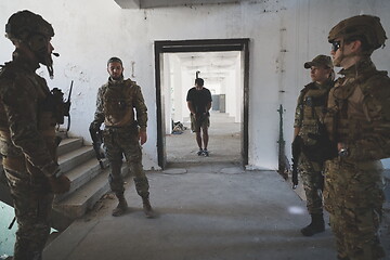 Image showing Videographer Taking Action Shoot of Soldiers in Action urban environment