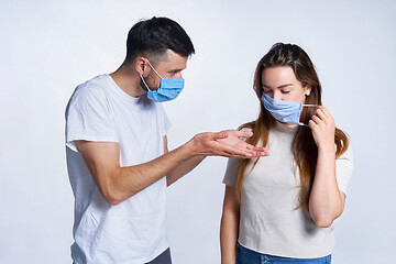 Image showing Young couple wearing medicine masks