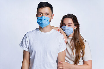 Image showing Young couple wearing medicine masks