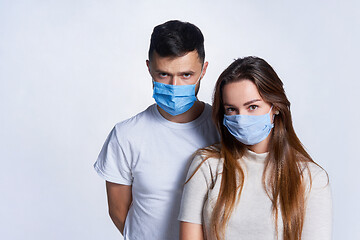 Image showing Young couple wearing medicine masks