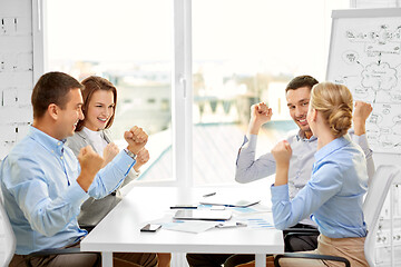 Image showing happy business team celebrating seccess at office