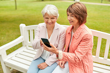 Image showing happy senior women with smartphone at summer park