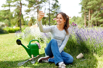 Image showing woman taking selfie by smartphone in summer garden