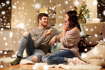 Image showing happy couple with gift box at home