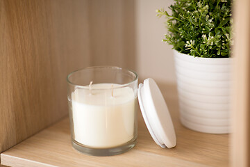 Image showing fragrance candle in glass holder on shelving