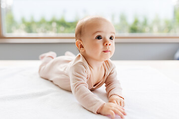 Image showing sweet baby girl lying on white blanket