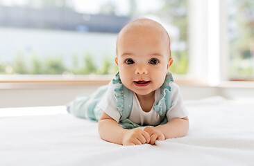 Image showing sweet baby girl lying on white blanket