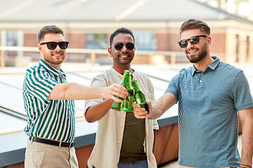 Image showing happy male friends drinking beer at rooftop party