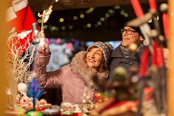 Image showing senior couple at christmas market souvenir shop