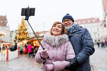 Image showing senior couple taking selfie at christmas market