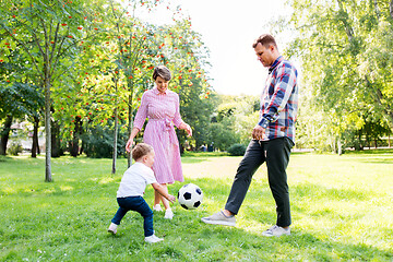 Image showing happy family playing soccer at summer park