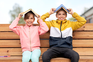 Image showing school children with books having fun outdoors