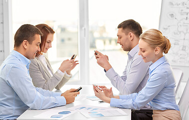 Image showing business team using smartphones at office