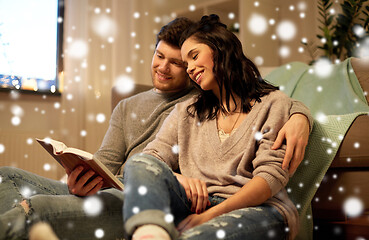 Image showing happy couple reading book at home