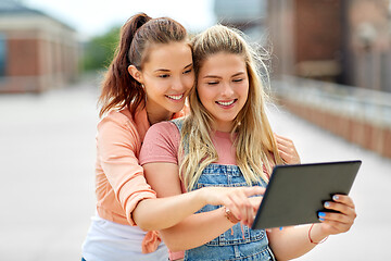 Image showing teenage girls with tablet computer on roof top