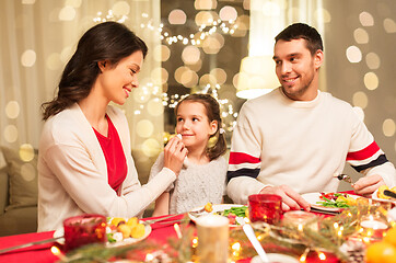 Image showing happy family having christmas dinner at home