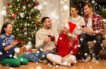 Image showing friends celebrating christmas and drinking wine