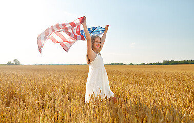 Image showing girl with american flag waving over cereal field