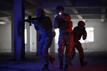 Image showing Soldiers squad in tactical formation having action urban environment