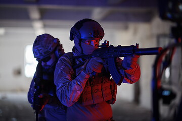 Image showing Soldiers squad in tactical formation having action urban environment