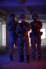 Image showing soldier squad team portrait in urban environment colored lightis