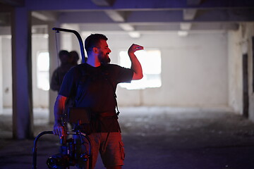 Image showing Videographer Taking Action Shoot of Soldiers in Action urban environment