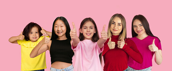 Image showing Portrait of young people on pink coral studio background, collage