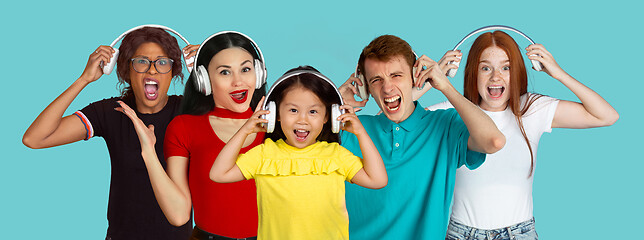 Image showing Portrait of young people on light blue studio background, collage