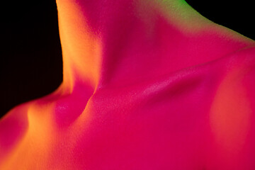 Image showing Close up portrait of female fashion model in neon light on dark studio background.