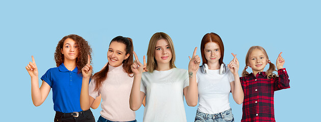 Image showing Portrait of young people on light blue studio background, collage