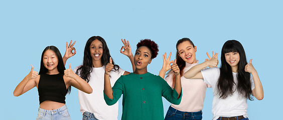 Image showing Portrait of young people on light blue studio background, collage