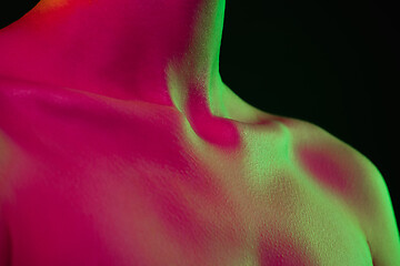 Image showing Close up portrait of female fashion model in neon light on dark studio background.