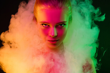 Image showing Portrait of female fashion model in neon light on dark studio background.