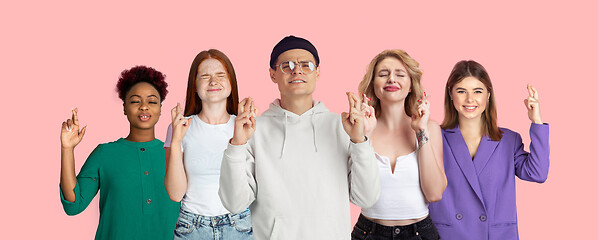 Image showing Portrait of young people on pink coral studio background, collage