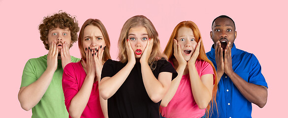 Image showing Portrait of young people on pink coral studio background, collage