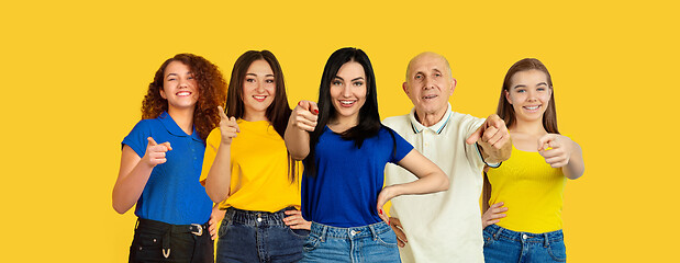 Image showing Portrait of young people on bright yellow studio background, collage