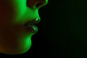 Image showing Close up portrait of female fashion model in neon light on dark studio background.
