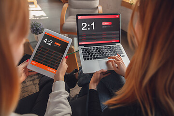 Image showing Close up laptop and smartphone screen with mobile app for betting and score