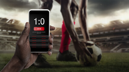 Image showing Smartphone screen with mobile app for betting and score, sportsman on background