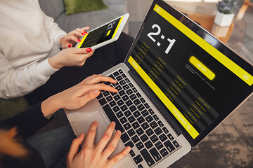 Image showing Close up laptop and smartphone screen with mobile app for betting and score