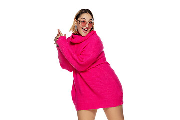 Image showing Beautiful young woman in bright pink comfortable sweater, long sleeve isolated on white studio background