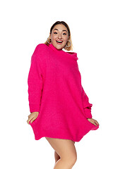 Image showing Beautiful young woman in bright pink comfortable sweater, long sleeve isolated on white studio background