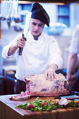 Image showing chef cutting big piece of beef